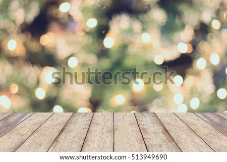Christmas holiday background with empty wooden table top over festive bokeh light decorate on tree. For create montage product display