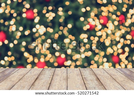 Christmas holiday background with empty wooden table top over festive bokeh light decorate on tree. For create montage product display