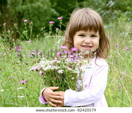 Little Smiling Girl with Bunch of Flowers Portrait