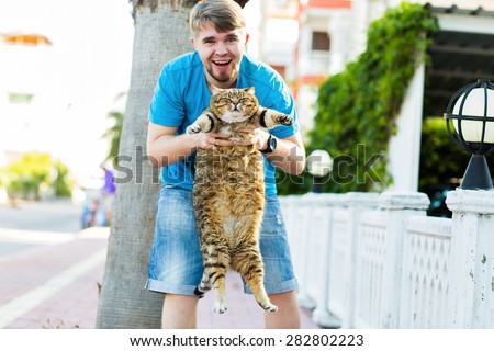 a man and a fat cat