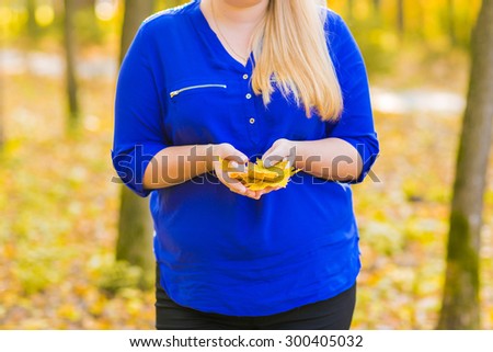 young girl walking in autumn park on yellow leaves
