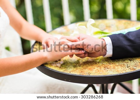 Wedding couple holding hands.  hands with wedding rings