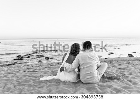 Couple enjoying the beach.  couple watching the sea