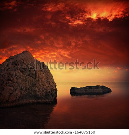 Red clouds and big stone in sea water. Square panorama with minimalism composition made from two photos