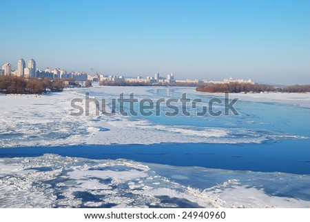 frozen river and city on horizon line