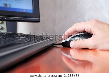 hand operating a mouse of computer