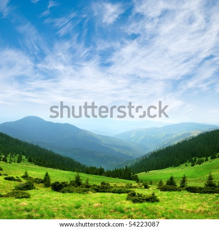 green mountain valley and blue sky with clouds