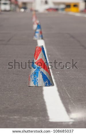 Fresh painted lines at road and traffic cone