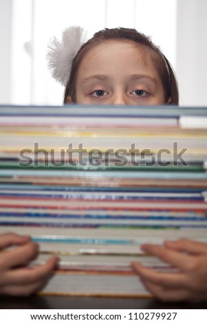 Cute little girl with books