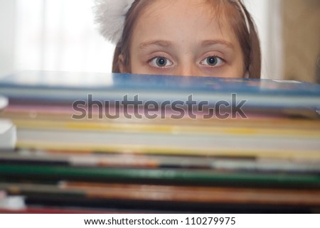 Cute little girl with books
