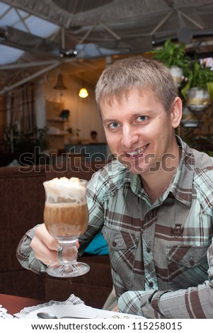 The young man drinks coffee.