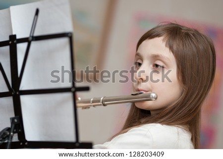 young girls playing the flute