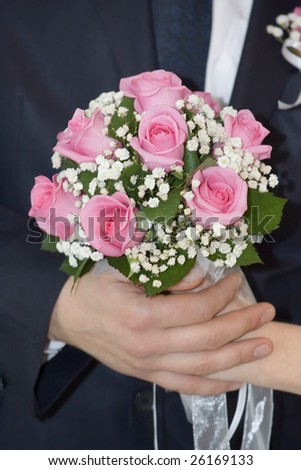 Rose flowers wedding bouquet, hands of bride and groom, traditional black and white wedding dress