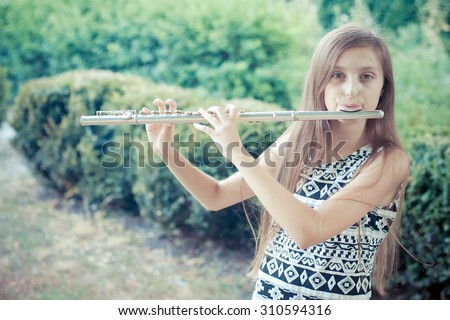 young girls playing the flute