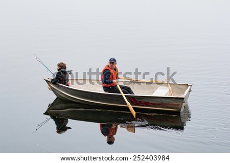 son and dad fishing in a row boat