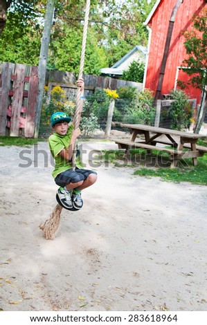 boy playing on a rope swing