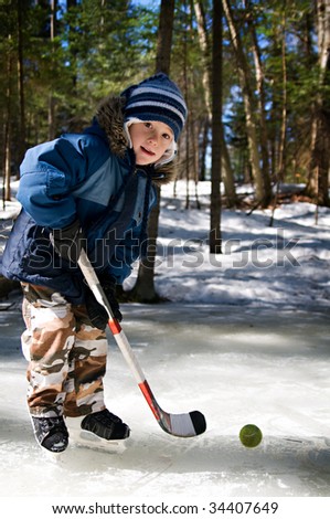 boy playing pond hockey