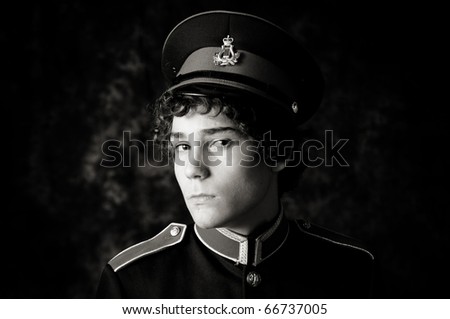 dramatic black and white portrait of a teen boy in his marching band uniform