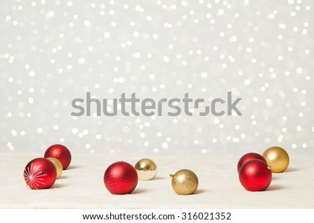 red and gold christmas balls and twinkle lights background