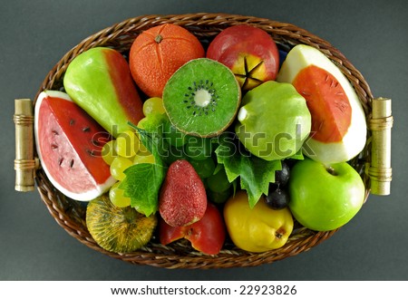 Fruits made of soap on basket, isolated background