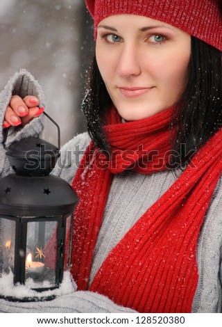 beautiful girl in winter forest with lantern