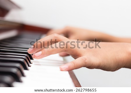 Children playing piano in the music room
