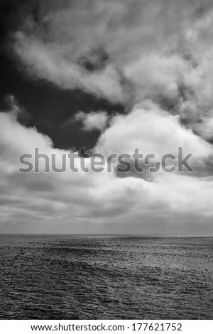 A black and white shot looking out to the Pacific Ocean just after a storm.