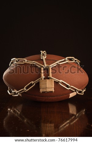 A close up of a football locked up with chain.