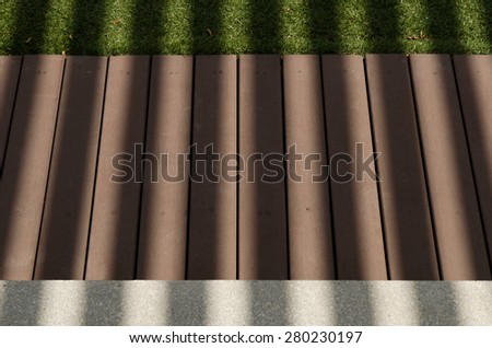Stripped shadow on wood,grass and concrete floor