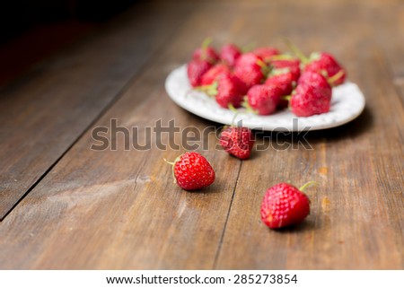 organic fresh sweet strawberries as a seasonal breakfast in the morning right from farmers market on dark wood table background decorated in rustic style