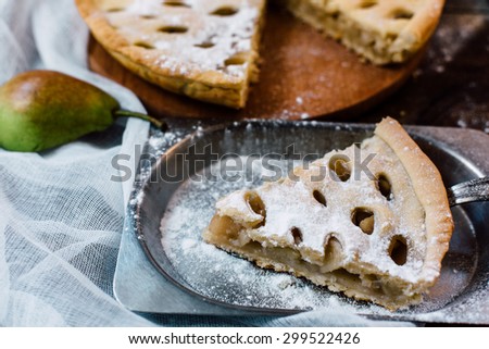 open vegetarian pear pie on wooden table in rustic style