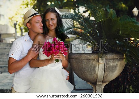 colorful photo of brides in beautiful sunny day in Cuba, close-up portrait of a bouquet of pink flowers