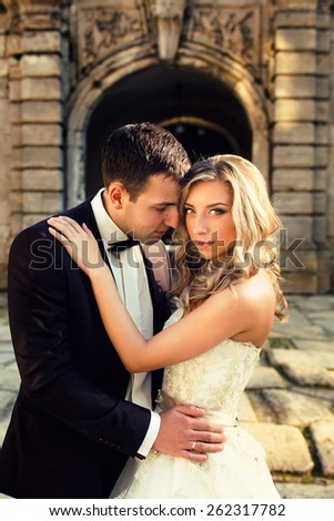 wedding fashion couple in sunset and old  architecture, yellow field