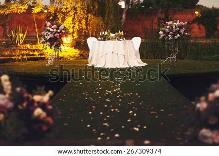 stylish wedding table decorated with flowers peonies and candles green terrace on the lake in garden Rome Italy