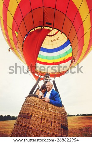 couple bride and groom in basket of balloon