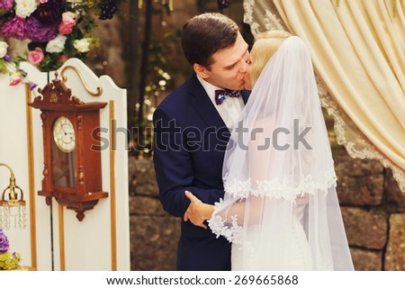 groom wipe away all tears from smiling blonde bride black and white