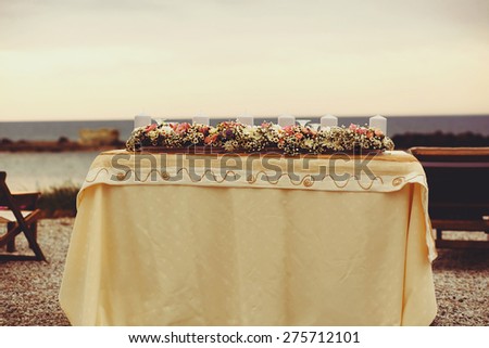 vintage decor wedding ceremony on the bank on the background of the sea near the island of Milos Greece