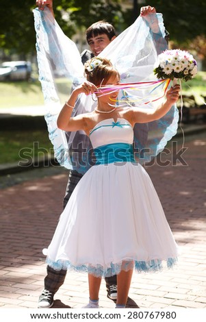 groom and bride make some fun