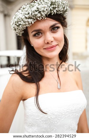 happy elegant cute stylish bride in crown on the background church