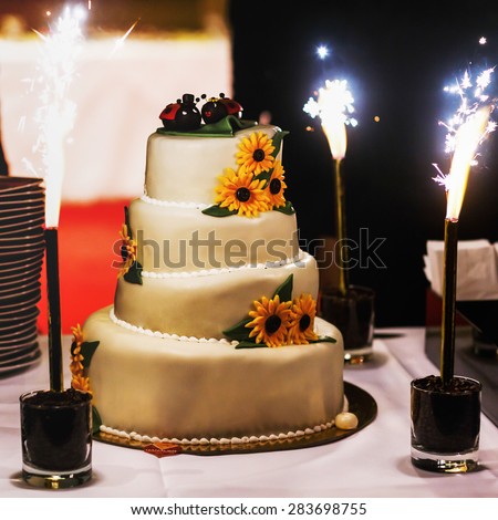 big white weddin cake decorate sunflowers ladybird and firework