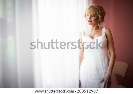 gentle beautiful stylish caucasian bride on the background pink wall
