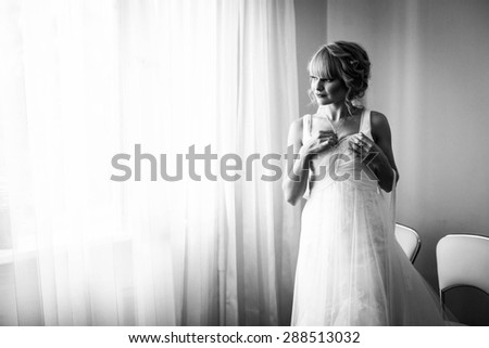 gentle beautiful stylish caucasian bride on the background pink wall