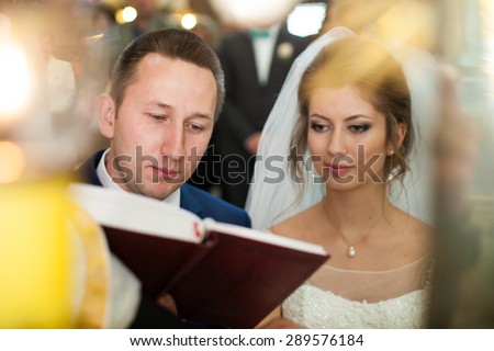 wedding ceremony of stylish elegant brunette bride and groom win the old church