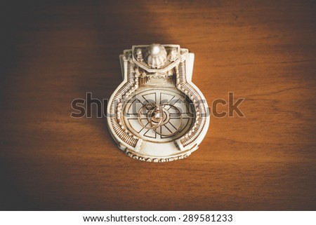 luxury amazing wedding rings on the souvenir statuette of a church on background of wooden table