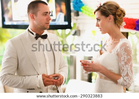 beautiful gorgeous blonde bride and stylish groom celebrating wedding on the restaurant terrace