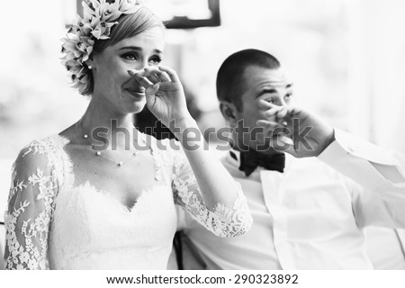 beautiful gorgeous blonde bride and stylish groom crying,  celebrating wedding on the restaurant terrace