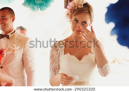 beautiful  gorgeous blonde bride crying  and stylish groom, hawai  colorful sand ceremony  on cyprus