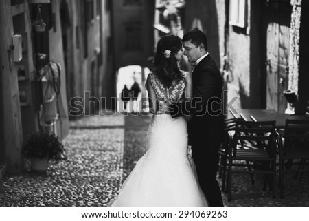 stylish romantic love full couple coming down the street of the ancient city, the Mediterranean sea, mountains