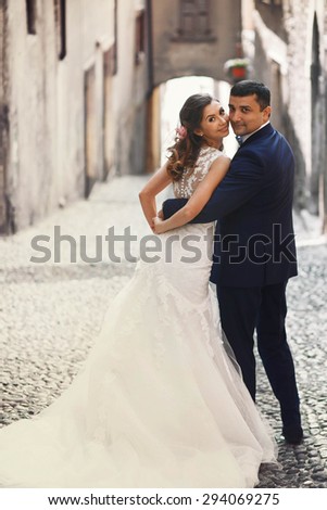 stylish romantic love full couple coming down the street of the ancient city, the Mediterranean sea, mountains