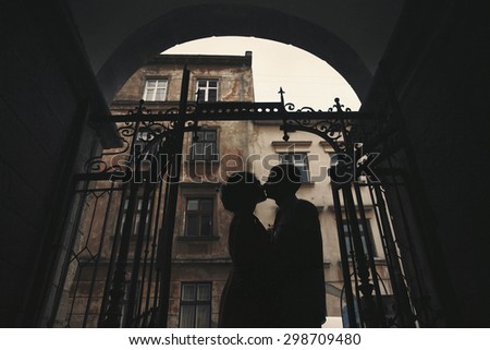 beautiful young happy stylish caucasian bride and groom on the background impressive architecture, Lviv, summer